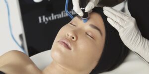 Person receiving a Hydrafacial treatment at Glo MD.