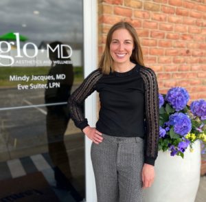 Dr. Mindy Jacques outside of office of glo MD Aesthetics and Wellness